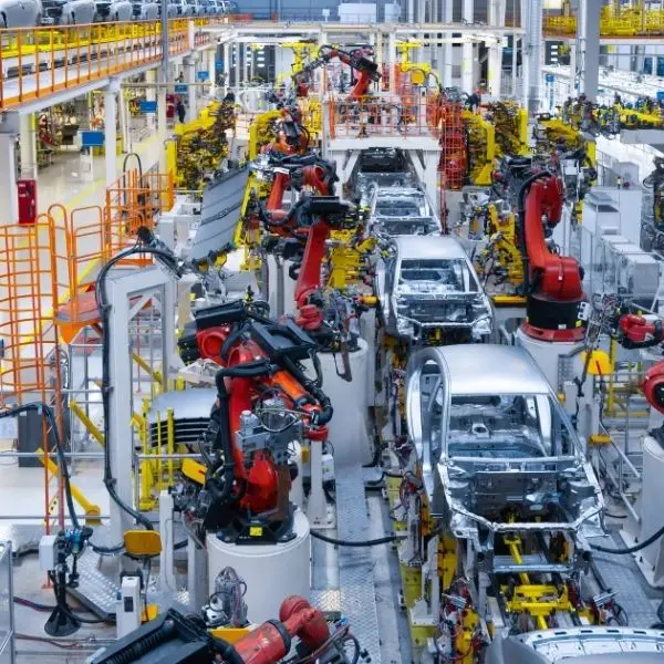 A factory with many cars on the assembly line